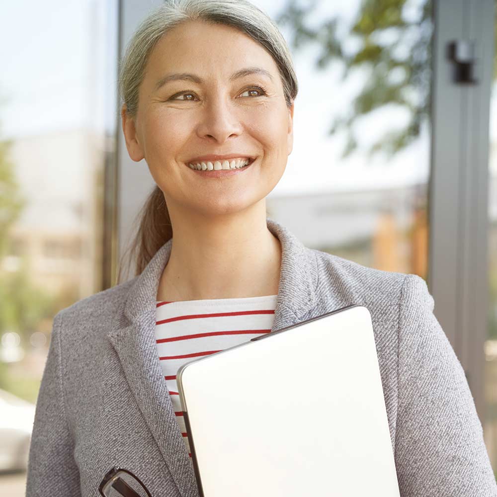 Senior woman holding laptop with research